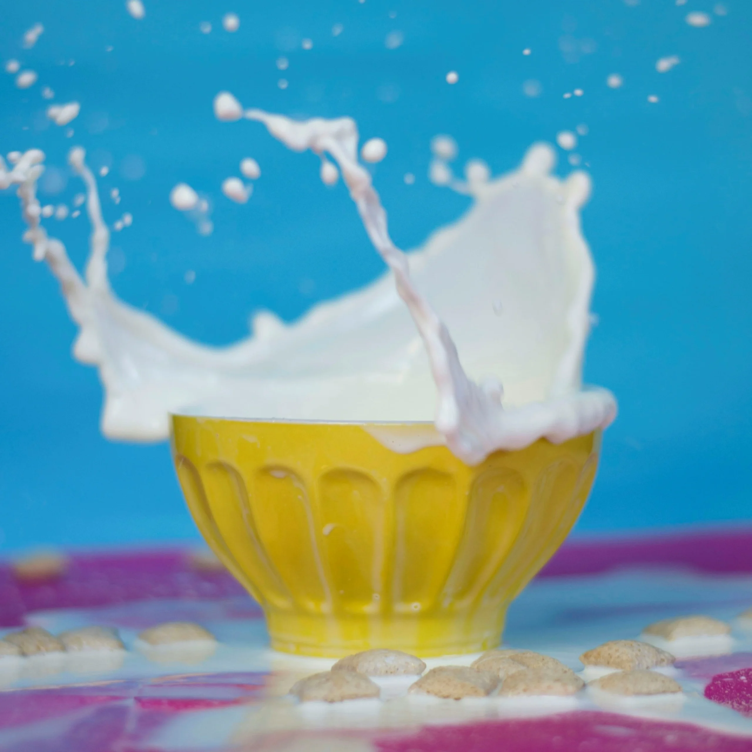 Splash of cream glue from yellow colored bowl