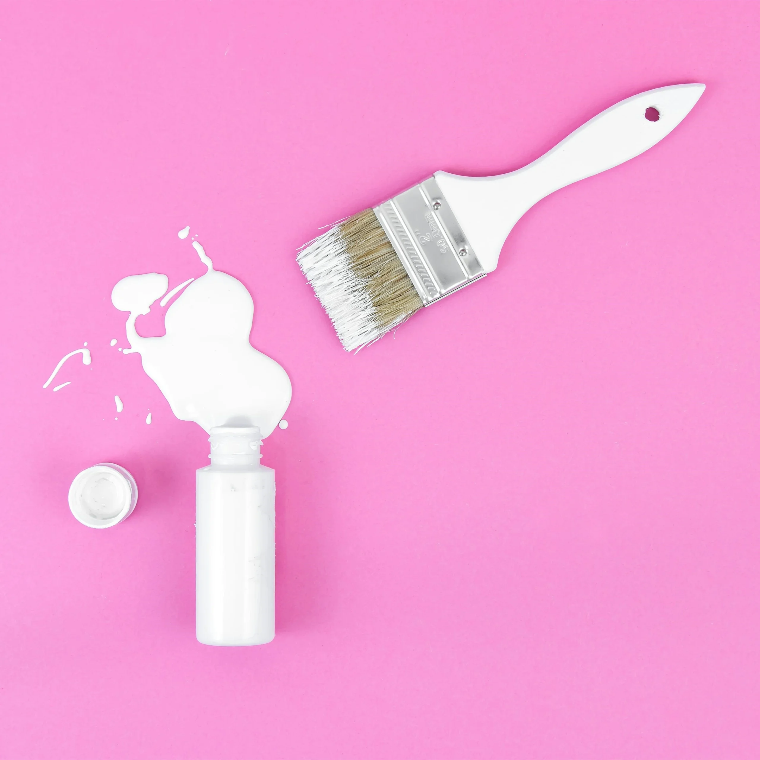 White color cream glue bottle with brush and pink background