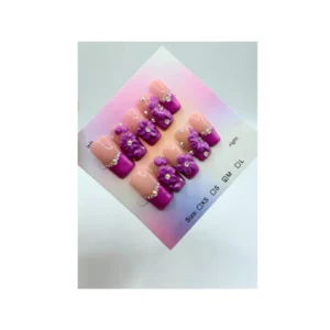 Designed with a nude base, bright purple French tips, delicate 3D purple flower clusters, and sparkling rhinestone accents, this set blends classic style with modern detail.