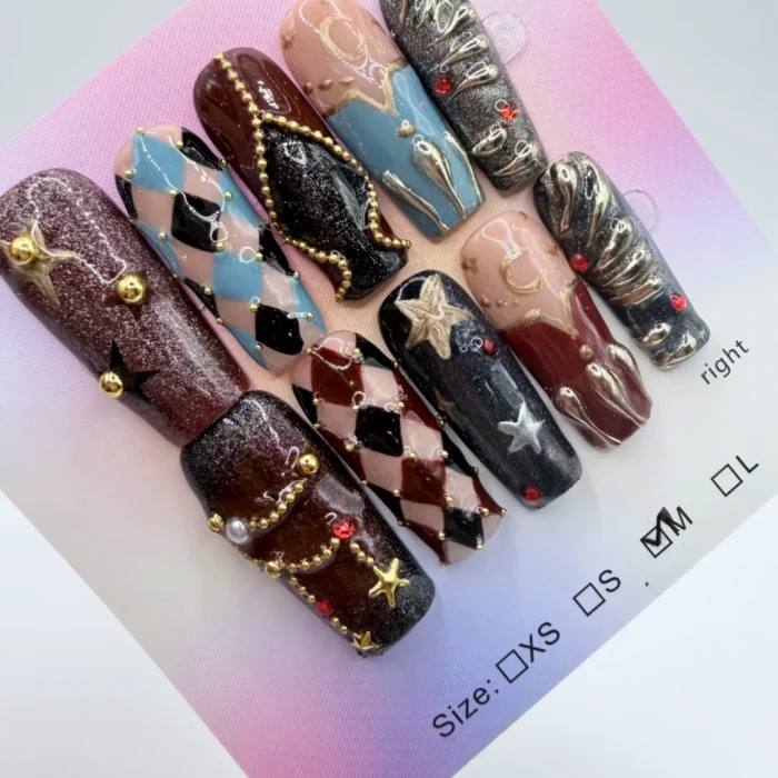 Luxury 3cm square press-on nails featuring a medieval gothic theme with 3D gold stars, crimson harlequin patterns, and celestial charms on a soft pink background.