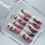 3cm long square press-on nails featuring pink and white aura ombre base with 3D silver chrome metallic heart and star designs in a clear storage box.