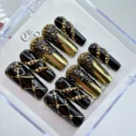 Handmade black and gold baroque press on nails featuring intricate handpainted 3D metallic scrollwork.
