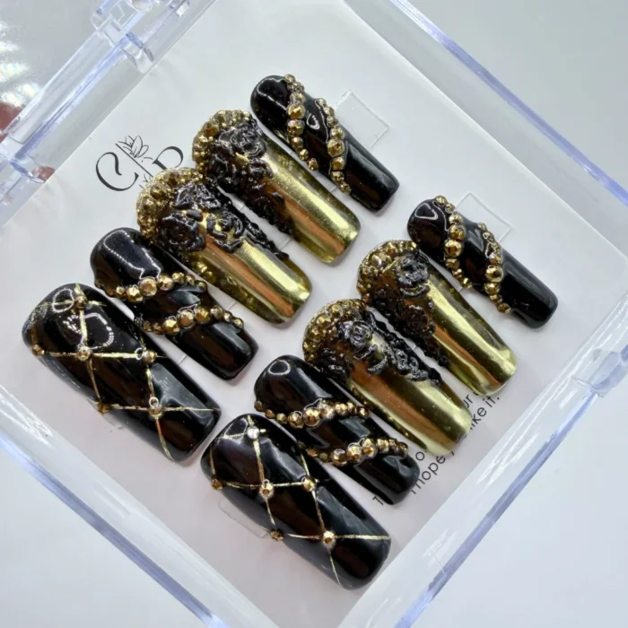Handmade black and gold baroque press on nails featuring intricate handpainted 3D metallic scrollwork.