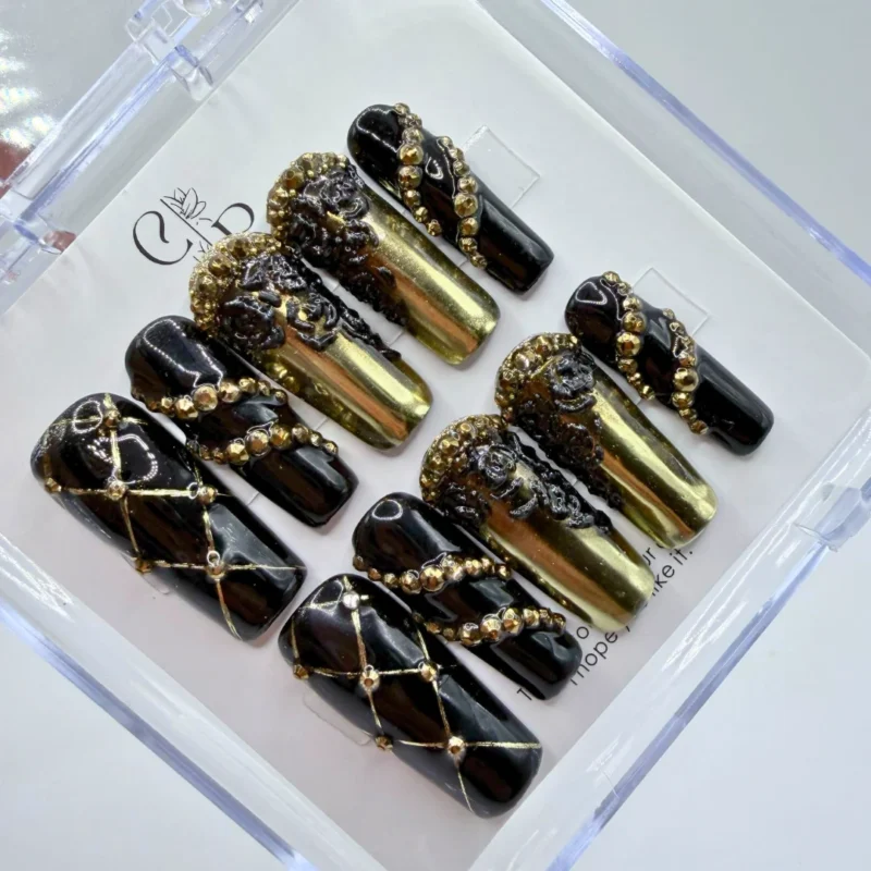 Handmade black and gold baroque press on nails featuring intricate handpainted 3D metallic scrollwork.
