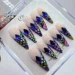 Vibrant neon animal print press on nails featuring bright lime green V cut French tips and hand-painted black leopard spots.